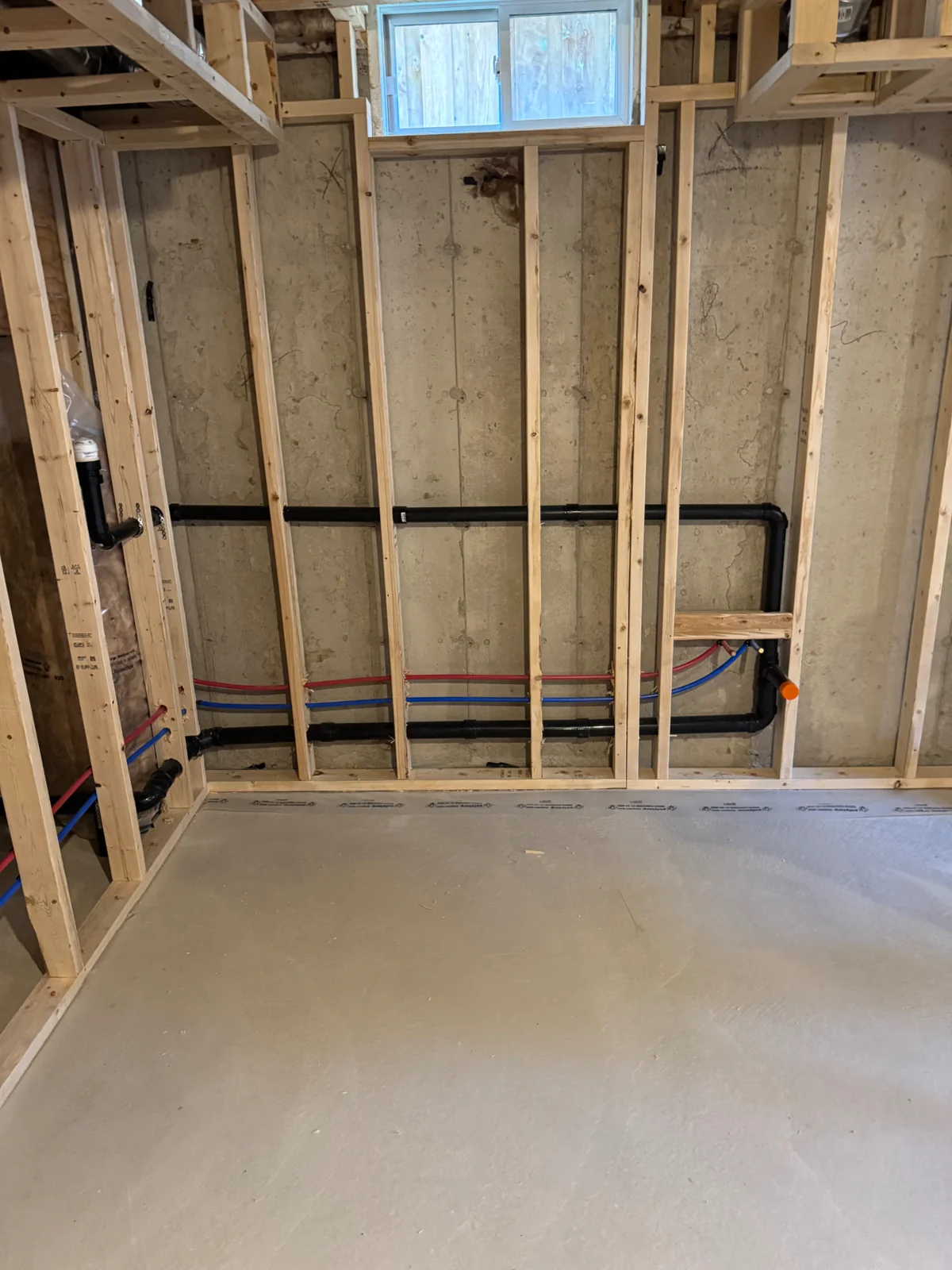 Drain and vent piping with water supply lines installed within a framed wall